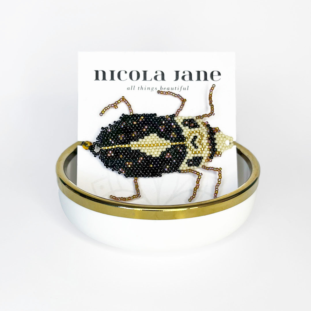 Beaded bracelet - black and gold bug