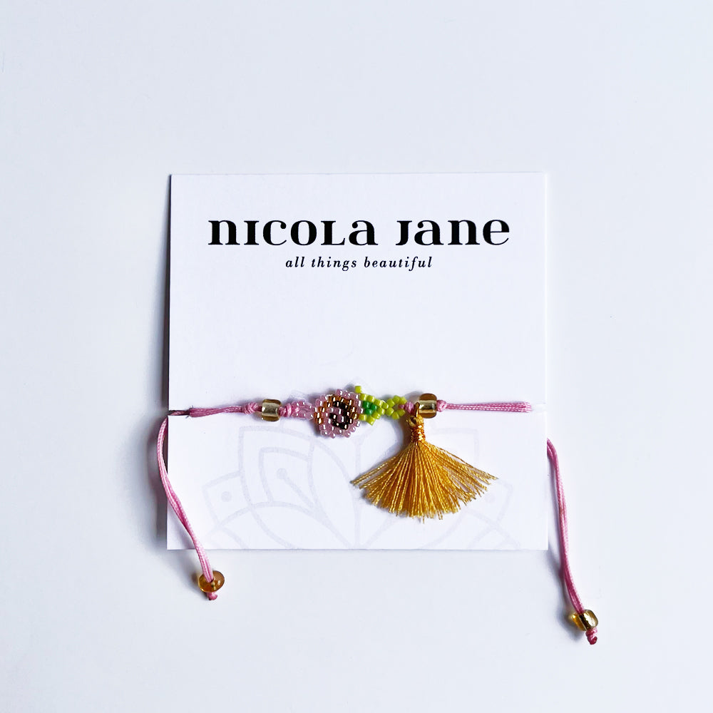 Small pink rose with tassel