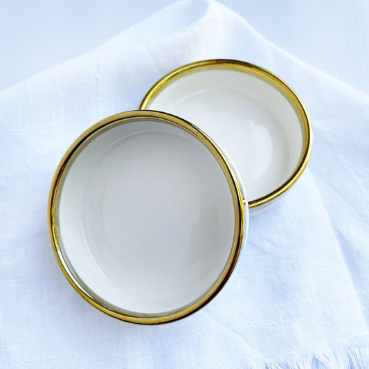 Small white ceramic bowls with a gold trim